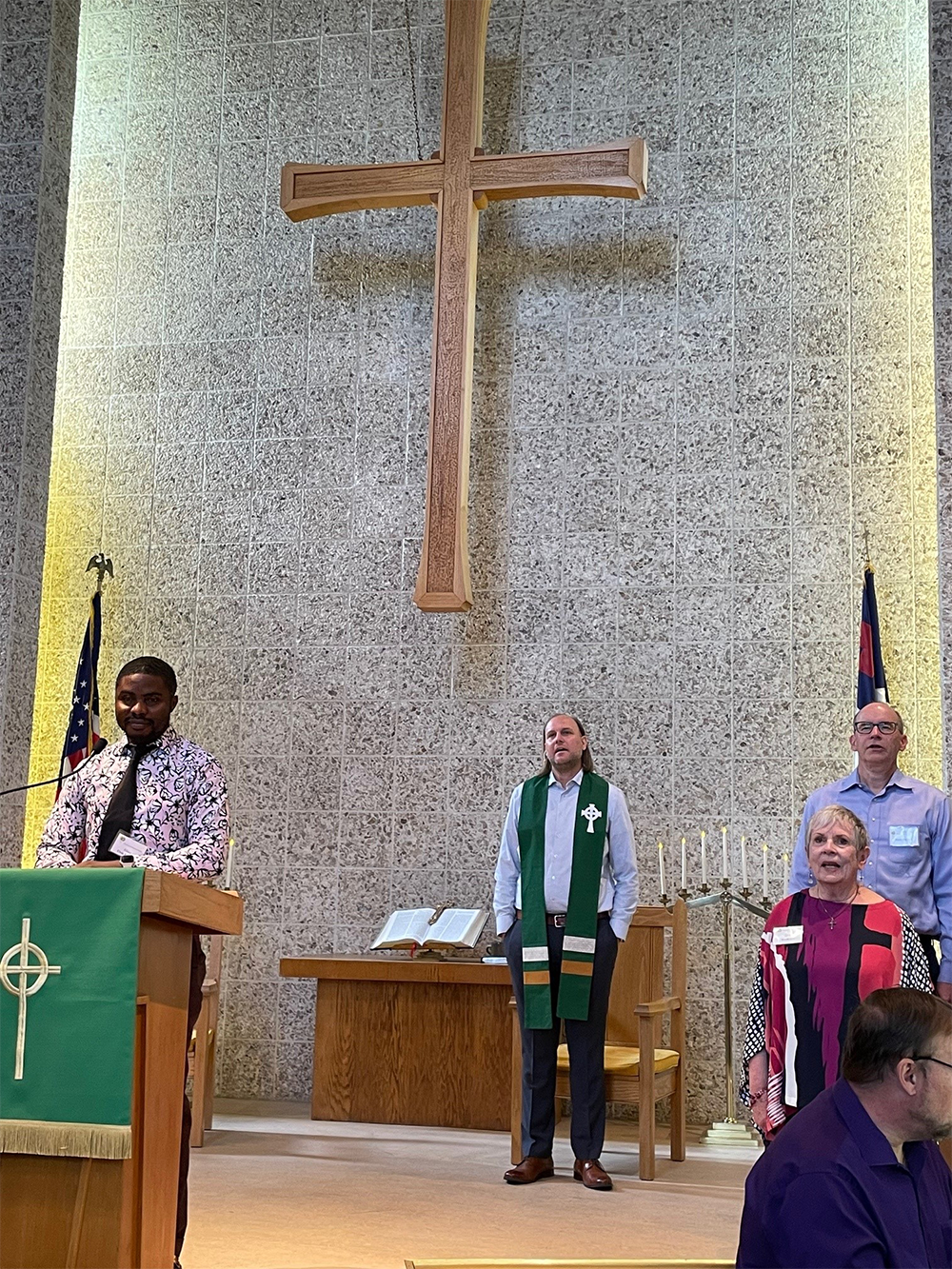 The Rev. Nathan Sautter (in green stole), pastor of the Cottonwood Presbyterian Church in Murray, leads worship on Sunday morning. Photo by Emily Odom.