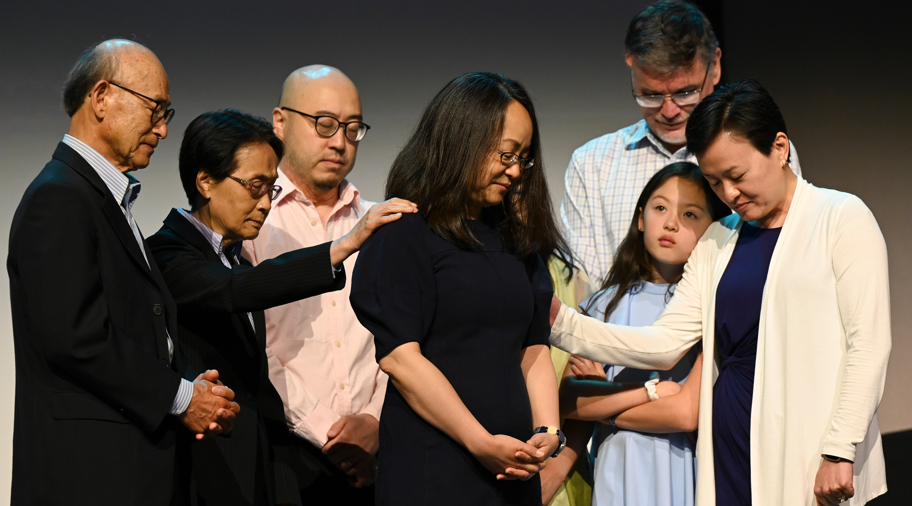 The Rev. Jihyun Oh is joined by her family on the platform to lay hands on her and participate in the litany of her installation as the next Stated Clerk of the General Assembly during the fourth plenary meeting on July 1, 2024. Photo by Rich Copley
