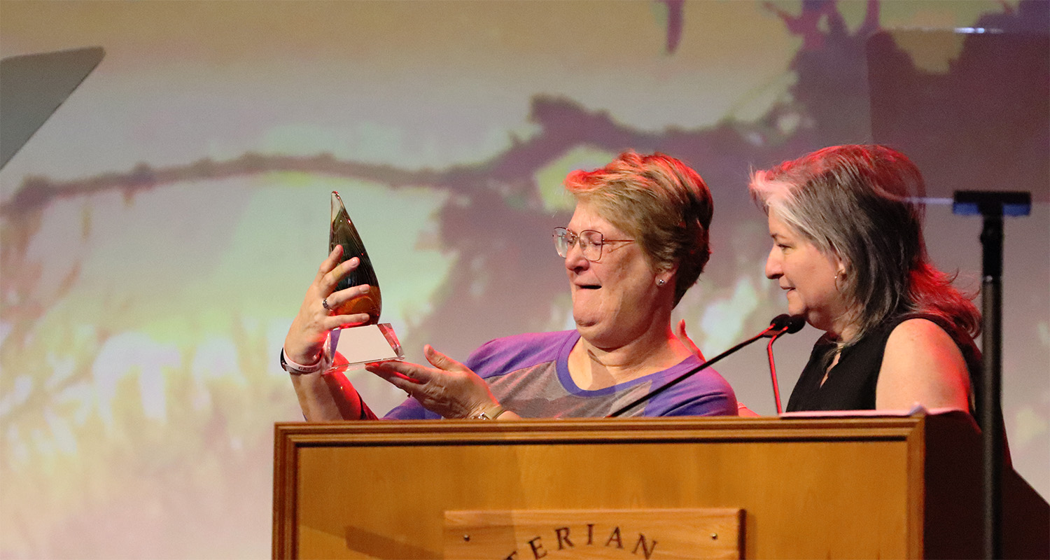 The Rev. Bronwen Boswell, Acting Stated Clerk of the General Assembly of the PC(USA) receives a hand-blown glass statuette from the Rev. Eliana Maxim, moderator of the Committee on the Office of the General Assembly, in recognition of her year of service to the Office of the General Assembly.