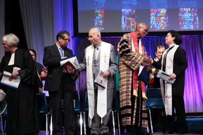 In Christ there is no east or west. Stated Clerk J. Herbert Nelson (second from right), with Rev. Najla Kassab (right), asks Presbyterians and Ecumenical friends Pass The Peace in Wednesday's Ecumenical Service of Worship.