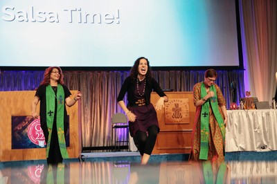Samantha Gonzalez-Block, associate pastor of Grace Covenant Presbyterian Church in Asheville, NC, leads a salsa dance break during the afternoon plenary session Thursday at the 223rd General Assembly.