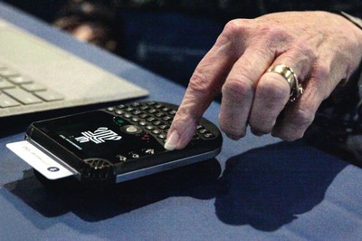 A commissioner at the 223rd General Assembly of the Presbyterian Church (U.S.A.) uses a computerized voting device to register their vote. 
