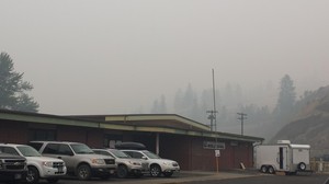 Smoke from the Clearwater Complex of fires hangs over the incident command post in Kooskia, Idaho.