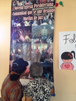 Two of the women from 9th Presbyterian in Barranquilla who were part of the sewing group. The motto on the banner says the church is “united in leaving footprints for peace.”