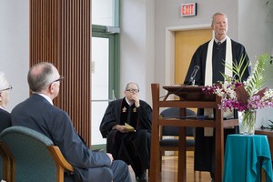 The Rev. David Maxwell (standing) preaches at the wedding of Paul Kempf and Robb Gwaltney on the familiar text on love from 1 Corinthians 13.