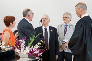 Paul Kempf and Robb Gwaltney (center l and r) exchange vows at the Presbyterian Center Chapel in Louisville.