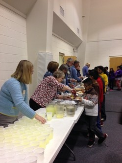 Church volunteers provide refreshments for students participating in after-school tutoring program.