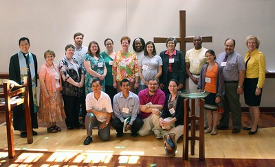 A group of people in front of a cross.