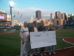 A group of men holding a large check.