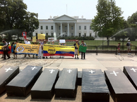 A group of people standing in front of the White House for a protest.