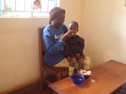 A woman feeding a child. 