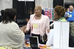 Earline Williams, new chief financial officer for the Presbyterian Mission Agency, visits with Big Tent participants in the exhibit hall.