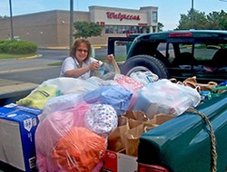 Hunger Action Enabler Jessica Fitzgerald loads her truck with clothing as well as health, food, and baby kits for Eastern Short migrant workers. 