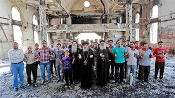 Christians in Minia, Egypt, worship in a burnt church Aug. 18.