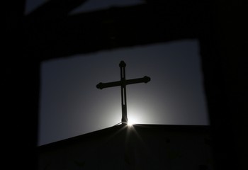 A cross on an underground Catholic church is silhouetted in Tianjin, Nov. 10, 2013.