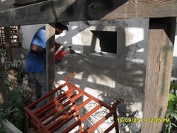 Haitian worker repairs portions of Holy Cross Hospital in Léogâne