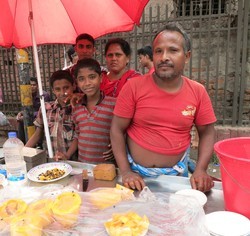 Rasel with his parents at their papaya stand.