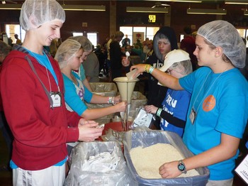 New Covenant youth prepare food for the hungry.