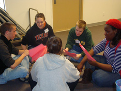 A group of young people sitting together in a circle.
