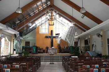 UCCP church in Tacloban with its roof peeled back and side windows blown out.