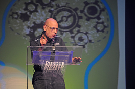 The Rev. Tony Campolo speaking from a lectern on a stage.