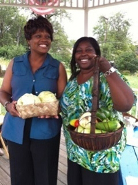 Two women holding baskets of produce.