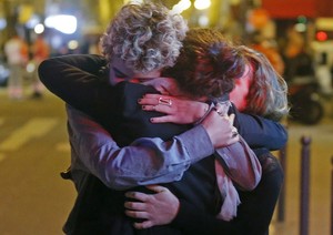 People hug on the street near the Bataclan concert hall after the fatal attacks in Paris. Gunmen and bombers attacked multiple locations around the city on Friday evening (Nov. 13, 2015), killing scores of people in what a shaken French president described as an unprecedented terrorist attack.