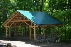 Volunteer alumni of Camp Holmes not only built, but raised $21,000, for their 25th anniversary “Raising the Scudder Roof” project completed in May.