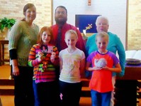 Three of the children who collected the offering with two of their Sunday school teachers and Pastor Tim Harmon (middle back).