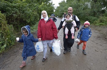 A Syrian refugee family enters Serbia after fleeing fighting in their home country. 