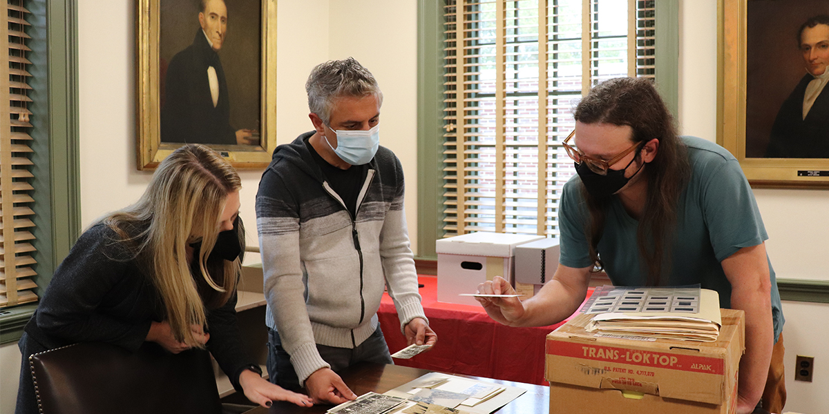Reza Aslan (middle) looks at collection materials with PHS staff members Natalie Shilstut (left) and David Staniunas (right). Photo by Kristen Gaydos.