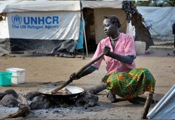 A South Sudan woman cooks in a refugee camp