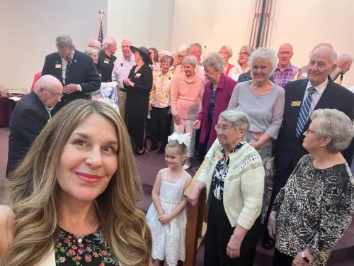 Rev. Dr. Judi McMillan & group posing for photo