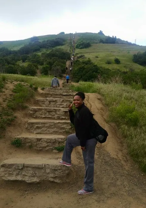 Around the Table blog Journey Neema standing on steps