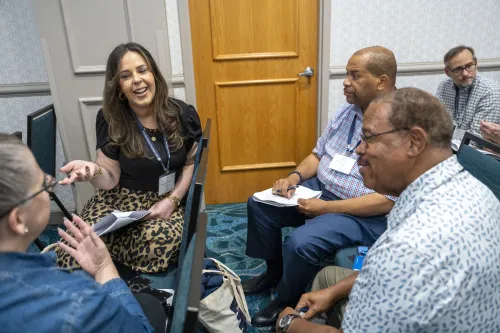 A group of people have a jovial conversation.