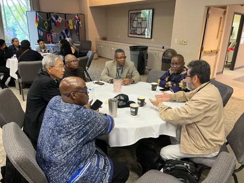 The Rev. Carlton Johnson sits with leaders at event on vital immigrant congregations, Presbytery of Greater Atlanta, 2023.