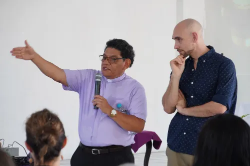 Joseph Russ listens as the Rev. Santiago Flores presents to a group of partners. 