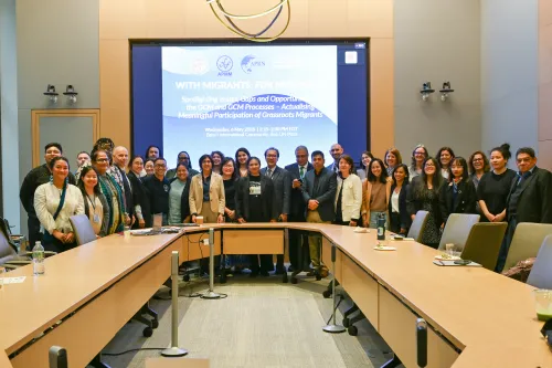 Attendees and panelists attend the “With Migrants, For Migrants” side event. 