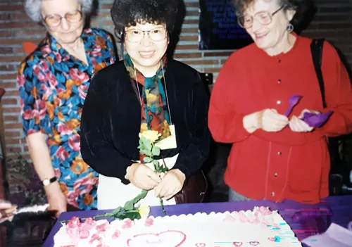 Jean Kim cuts the cake at a Church of Mary Magdalene anniversary celebration.