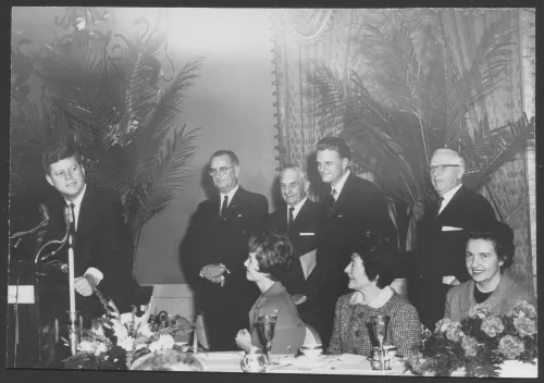 President Kennedy, top government leaders, and evangelist Billy Graham are shown as they paid a visit to the 3rd Annual Congressional Wives Prayer Breakfast in Washington, D.C. 