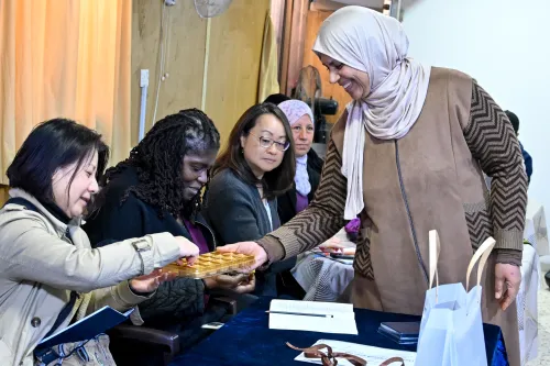 Sue Rheem receives chocolate made by a client of the Middle East Council of Churches' Department of Service to Palestinian Refugees. Presbyterian Church (U.S.A.) staff visiting the Holy Land met with leaders and clients of MECC/DSPR, an organization that helps in the Gaza Refugee Camp in Jerash do entreprenurial work to support themselves.
