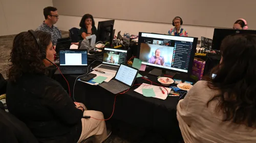people at tables looking at screens