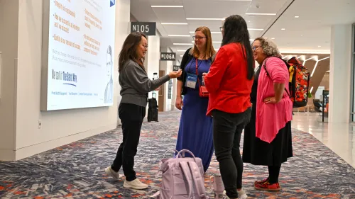 The Rev. Jihyun Oh checks in with committee leadership team member as the last day of GA227 committee meetings come to a close. Photo by Rich Copley