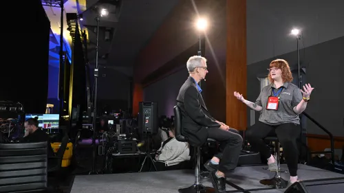 two people talking at side of backstage area