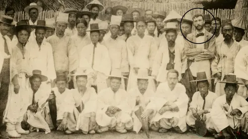 Dr. Speer, right of center, is bare-headed, bearded, + wears black bow tie. Dr. Speer, new Board Sec., was on a trip around the world to study missions. He visited Pyengyang station with Rev. Graham Lee (who is at left in the picture wearing western style straw hat). They walked from Pyengyang to Seoul, + this group of Koreans went with them as far as Whangju, where this picture was taken. 1897, Pearl Digital Collections.