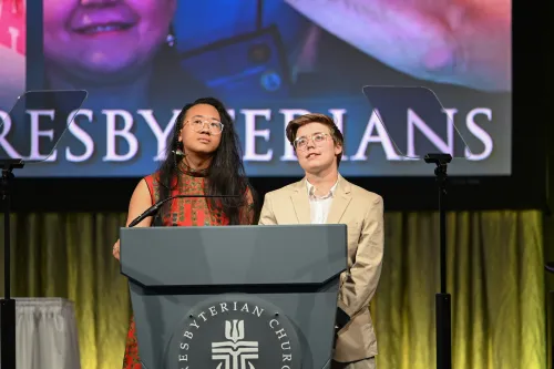 Theological Advisory Delegates Bee Wang (left) and Katie Reome (right) open the twelfth plenary of GA227 with prayer on Wednesday evening, July 1, 2026.