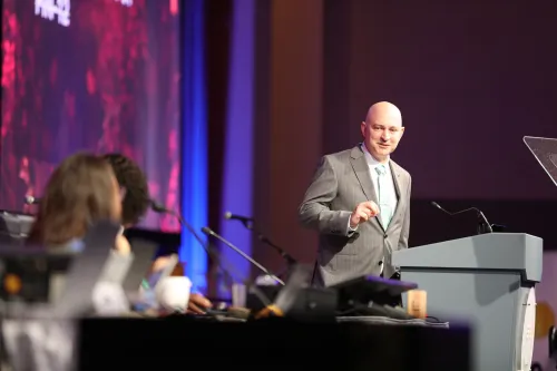 Ian Hall, President of A Corp discussing financials during GA227