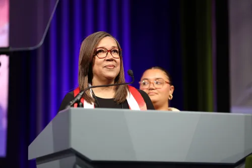 Rosa Colón Rodríguez standing behind podium at GA227