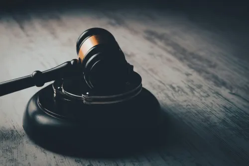gavel resting atop a gray wooden surface