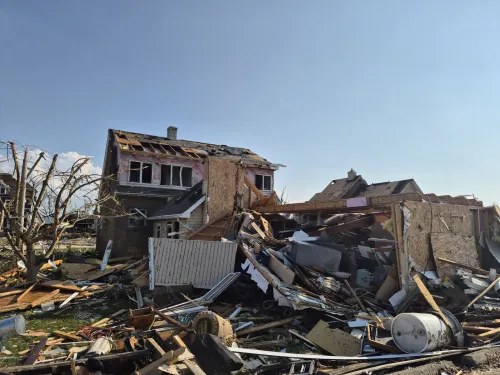 Home damaged by a storm is seen amid other debris